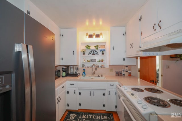 kitchen with white cabinets, stainless steel fridge, and sink