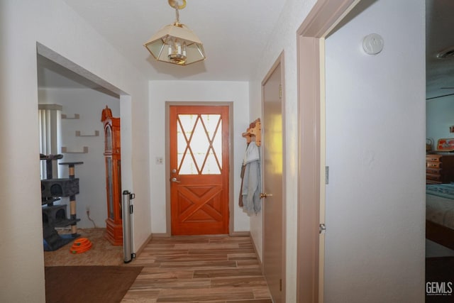 doorway to outside with light wood-type flooring