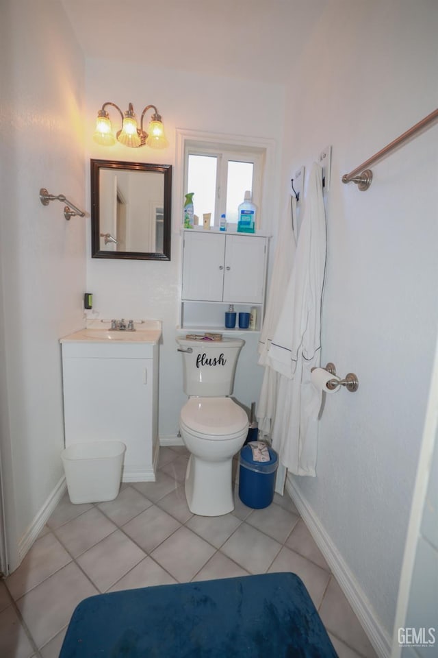 bathroom with tile patterned flooring, vanity, and toilet