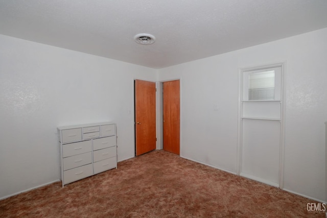 unfurnished bedroom with light colored carpet