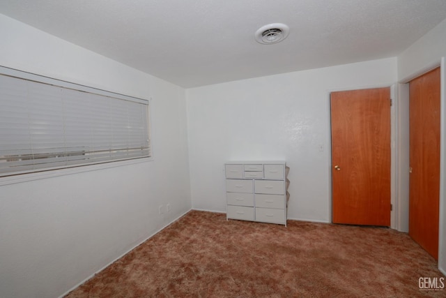 interior space with light colored carpet and a closet