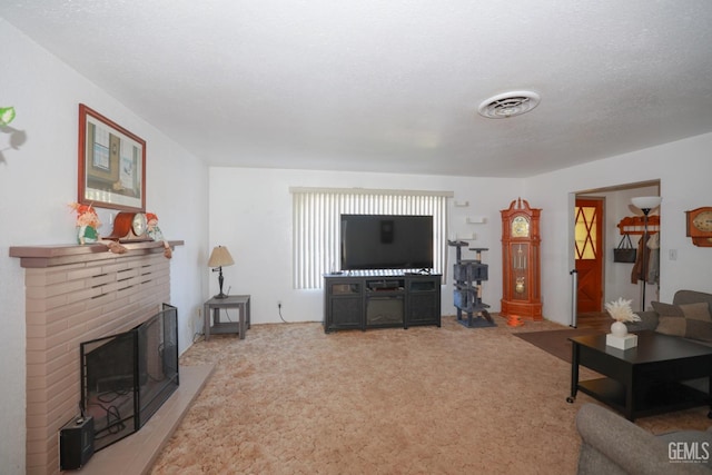 living room with a fireplace, carpet, and a textured ceiling