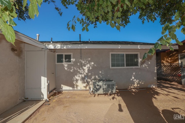 rear view of property with central AC unit