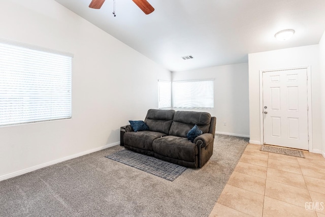 tiled living room with lofted ceiling and ceiling fan