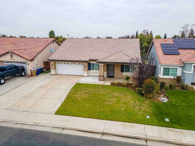 view of front of house featuring a garage, a front yard, and solar panels