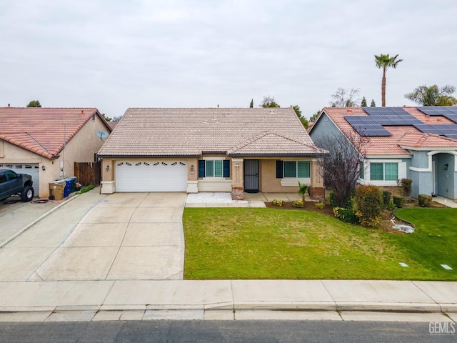 view of front of house featuring a garage, a front yard, and solar panels