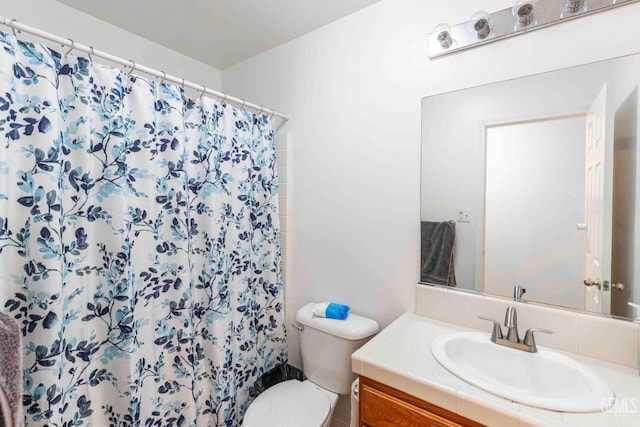 bathroom featuring vanity, toilet, and a shower with shower curtain