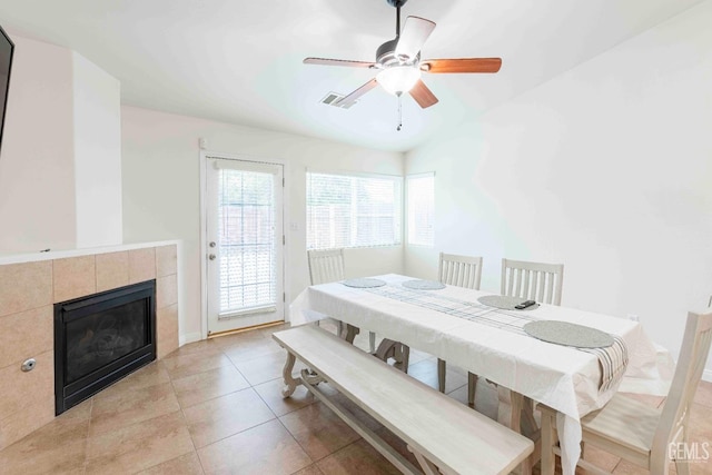 bedroom with a fireplace, light tile patterned floors, access to outside, and ceiling fan