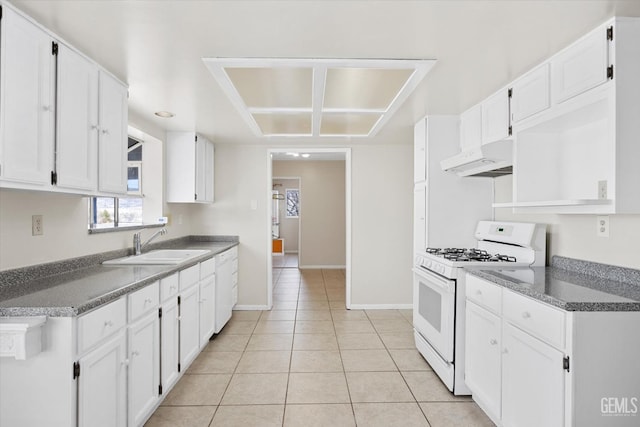 kitchen featuring light tile patterned flooring, under cabinet range hood, white appliances, a sink, and white cabinetry