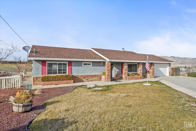 single story home with driveway, brick siding, crawl space, fence, and a front yard