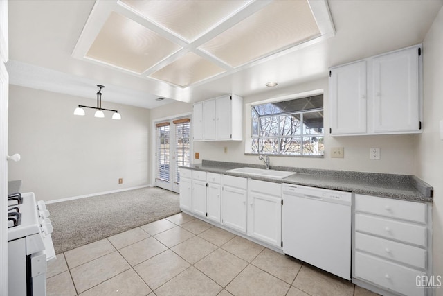 kitchen with white appliances, light tile patterned floors, white cabinets, light colored carpet, and a sink