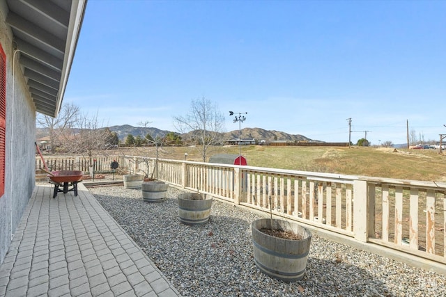 view of patio / terrace with a mountain view and fence