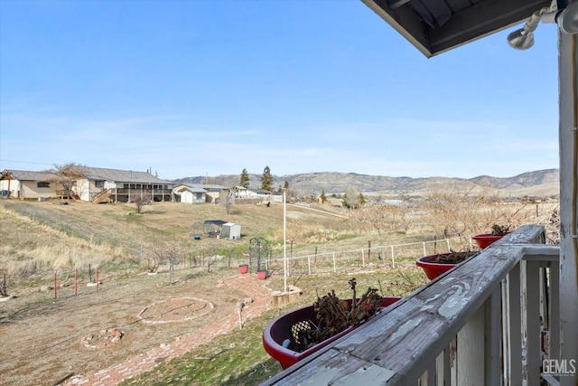 view of yard featuring a mountain view and fence