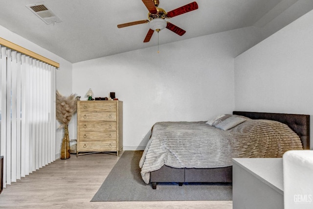 bedroom featuring vaulted ceiling, ceiling fan, and light hardwood / wood-style floors