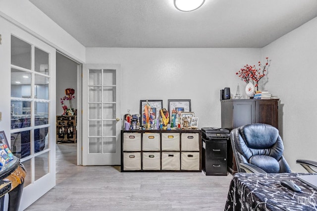 interior space with french doors and light wood-type flooring