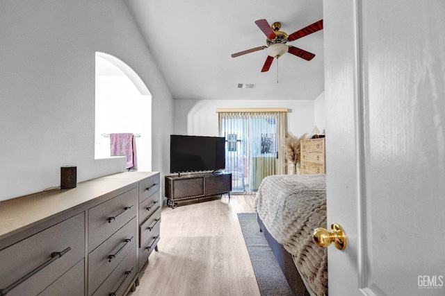 bedroom with access to exterior, vaulted ceiling, light hardwood / wood-style floors, and ceiling fan