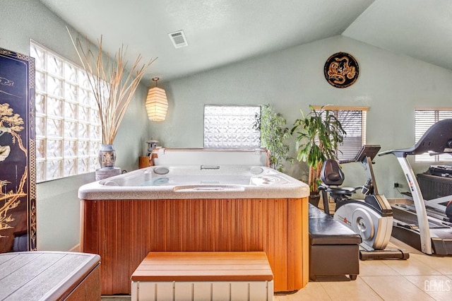 bathroom with tile patterned flooring and vaulted ceiling