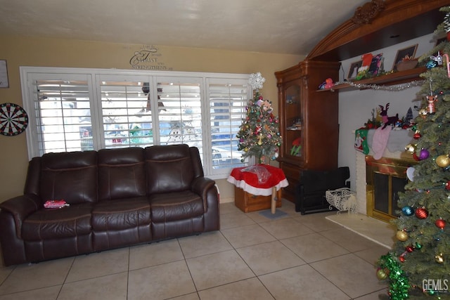 tiled living room featuring lofted ceiling