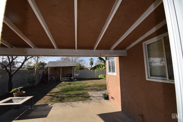 view of patio featuring a storage unit