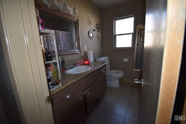 bathroom featuring tile patterned flooring, vanity, and toilet