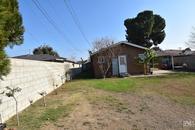 rear view of property with a lawn