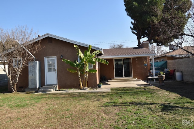 back of house with a lawn