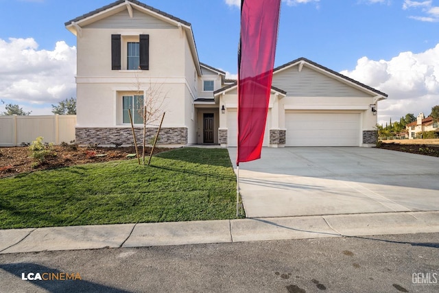 view of front of home featuring driveway, stone siding, fence, a front yard, and a garage