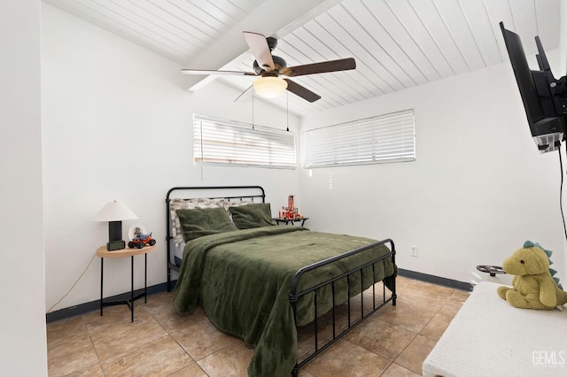 bedroom with lofted ceiling with beams, light tile patterned flooring, ceiling fan, wooden ceiling, and baseboards