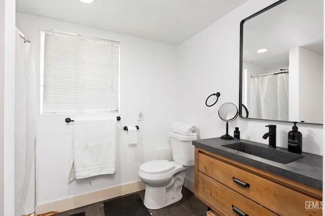 full bathroom with toilet, tile patterned flooring, baseboards, and vanity