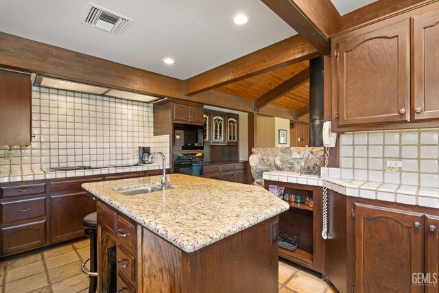 4227 Poso Flat Rd, Bakersfield, CA 93308 - kitchen featuring visible vents, a sink, black appliances, and tasteful backsplash