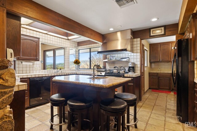 4227 Poso Flat Rd, Bakersfield, CA 93308 - kitchen with decorative backsplash, visible vents, a sink, black appliances, and wall chimney exhaust hood