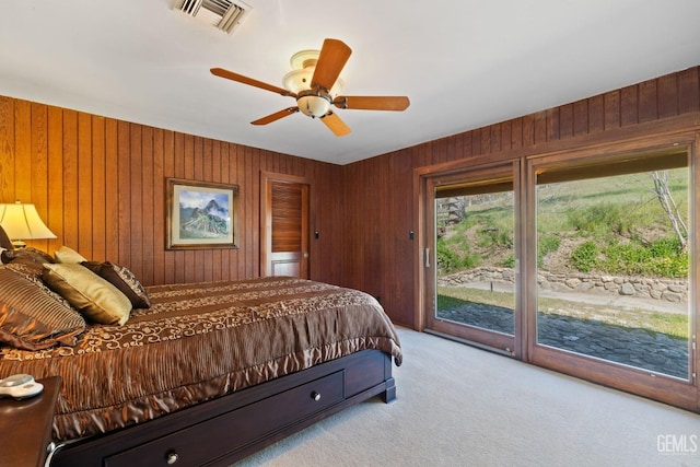 4227 Poso Flat Rd, Bakersfield, CA 93308 - bedroom with a ceiling fan, access to exterior, visible vents, wooden walls, and carpet