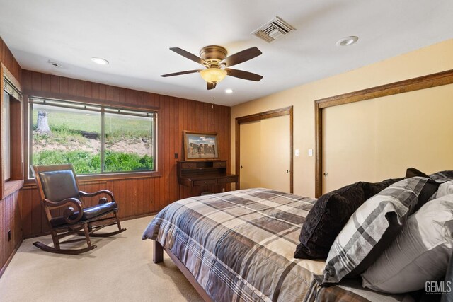 4227 Poso Flat Rd, Bakersfield, CA 93308 - bedroom with visible vents, multiple closets, wooden walls, recessed lighting, and light colored carpet
