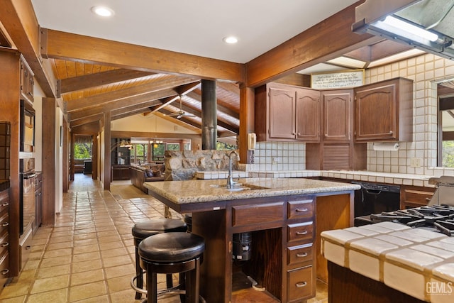4227 Poso Flat Rd, Bakersfield, CA 93308 - kitchen with tile counters, a wealth of natural light, black appliances, and tasteful backsplash