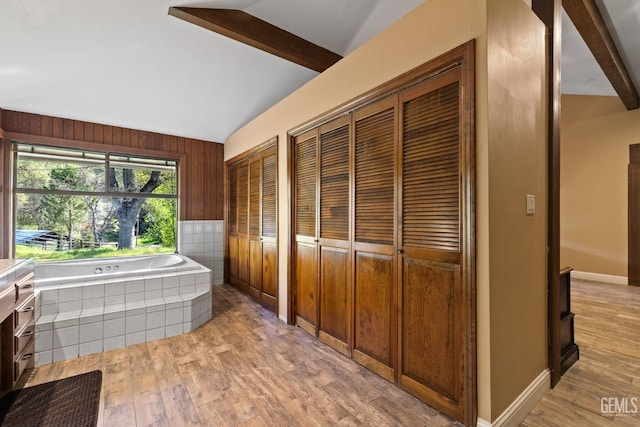 4227 Poso Flat Rd, Bakersfield, CA 93308 - bathroom with wooden walls, lofted ceiling with beams, wood finished floors, and a garden tub
