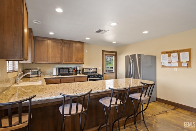 4227 Poso Flat Rd, Bakersfield, CA 93308 - kitchen featuring visible vents, a peninsula, baseboards, a sink, and appliances with stainless steel finishes