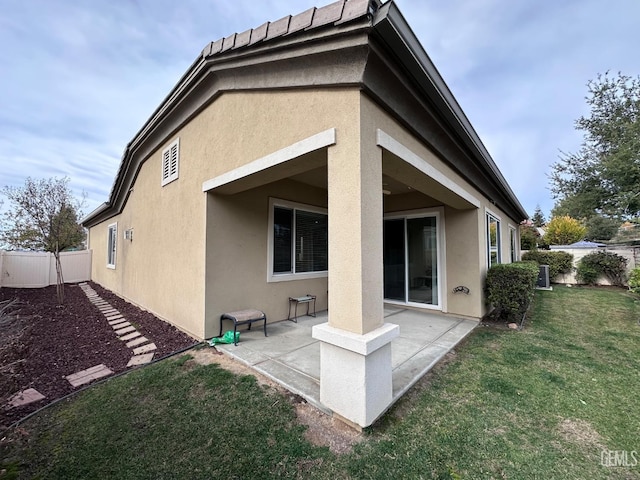 rear view of property with a yard and a patio