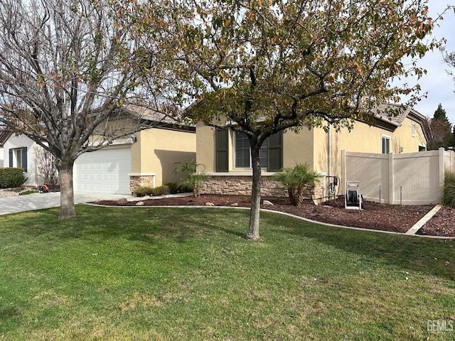 view of front of property featuring a garage and a front lawn