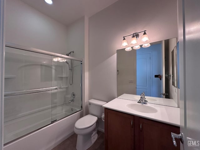 full bathroom featuring shower / bath combination with glass door, vanity, and toilet