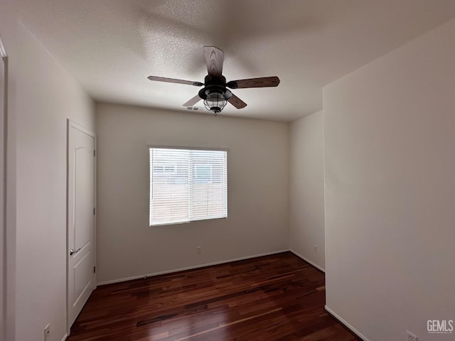 spare room featuring a textured ceiling, ceiling fan, and dark hardwood / wood-style floors