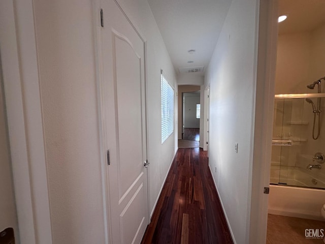 hallway with dark wood-type flooring