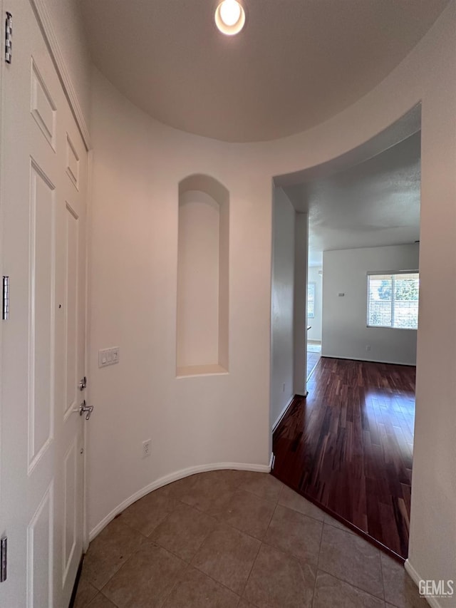 hall with tile patterned flooring