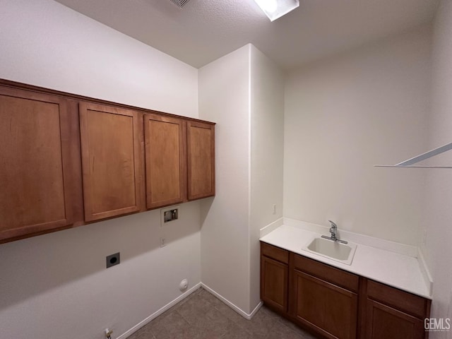 laundry area featuring gas dryer hookup, cabinets, sink, washer hookup, and hookup for an electric dryer