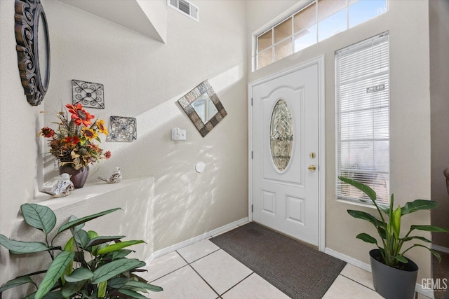 entrance foyer featuring light tile patterned floors and a wealth of natural light