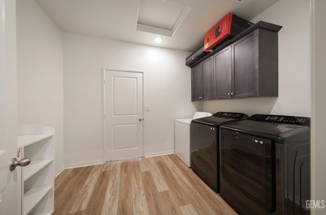 10213 Breitenbush Ave, Bakersfield, CA 93311 - washroom with washing machine and clothes dryer, light wood-style flooring, attic access, cabinet space, and baseboards
