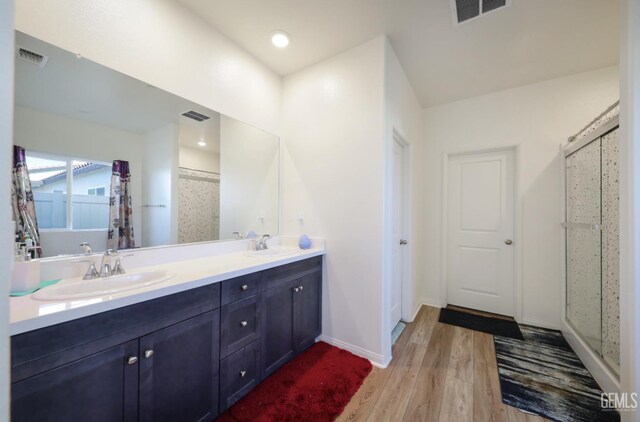 10213 Breitenbush Ave, Bakersfield, CA 93311 - full bath with wood finished floors, a shower, double vanity, and baseboards