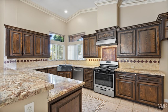 11808 Wethersfield St, Bakersfield, CA 93312 - kitchen with appliances with stainless steel finishes, light tile patterned floors, dark brown cabinets, light stone countertops, and crown molding