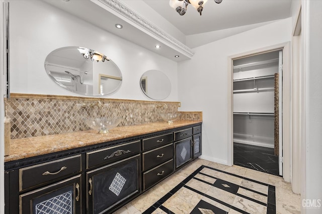 11808 Wethersfield St, Bakersfield, CA 93312 - bathroom with inlaid floor details, double vanity, a chandelier, recessed lighting, and a walk in closet