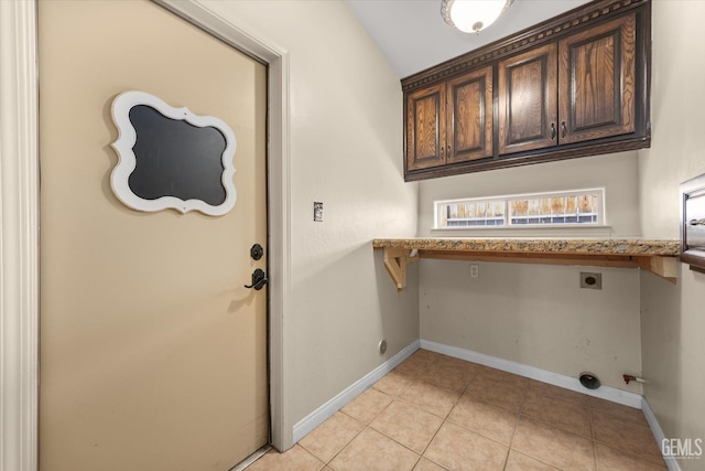 11808 Wethersfield St, Bakersfield, CA 93312 - laundry room featuring cabinet space, hookup for an electric dryer, and light tile patterned flooring