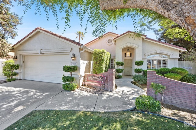 9000 Willamette Ct, Bakersfield, CA 93312 - mediterranean / spanish-style home featuring stucco siding, an attached garage, concrete driveway, and a tile roof